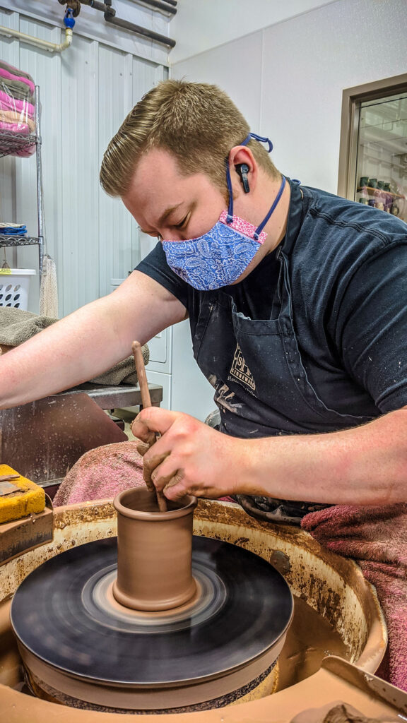 Sunset Hill Stoneware potter wearing a mask