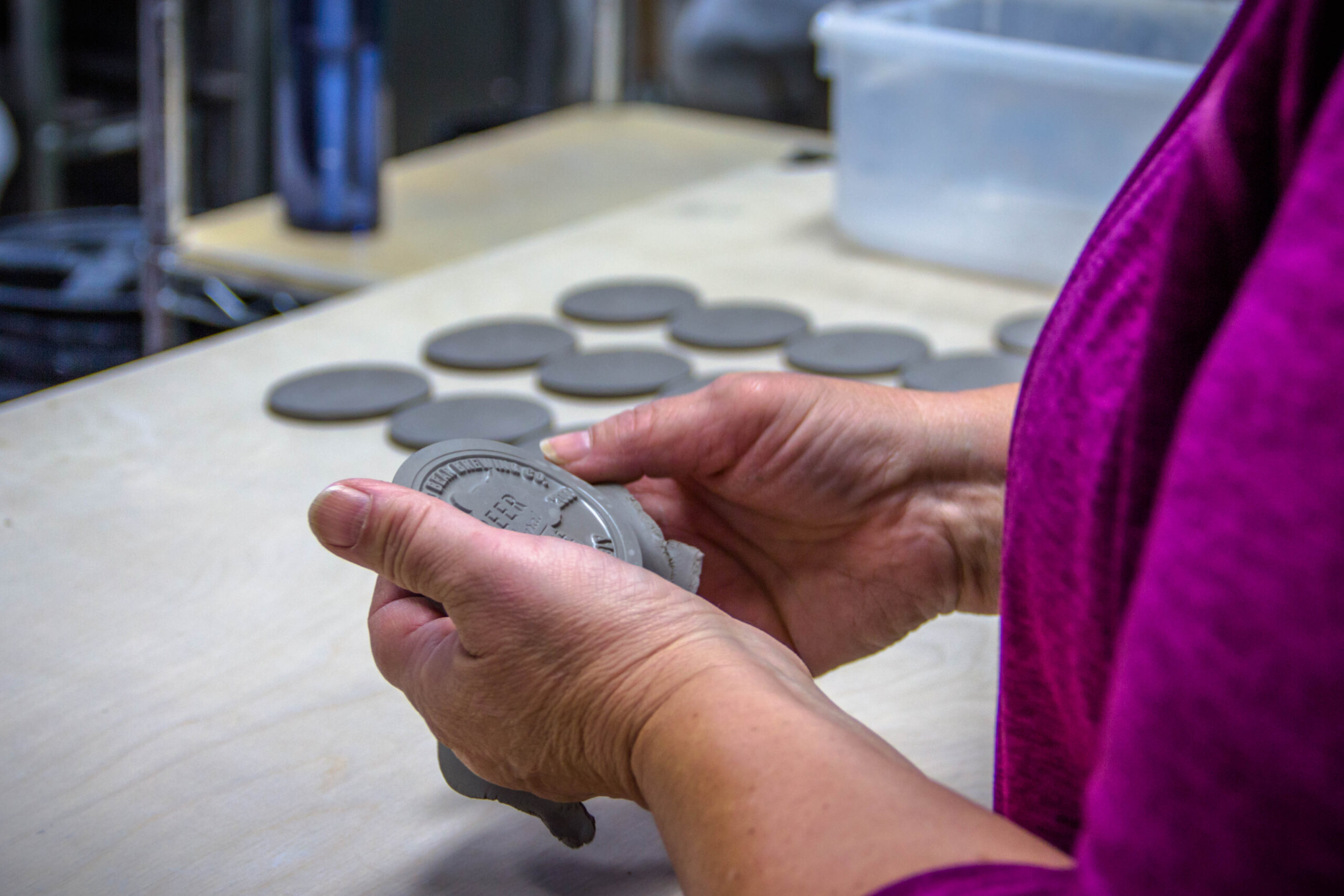 Cutting out medallions for Custom Pottery Mugs
