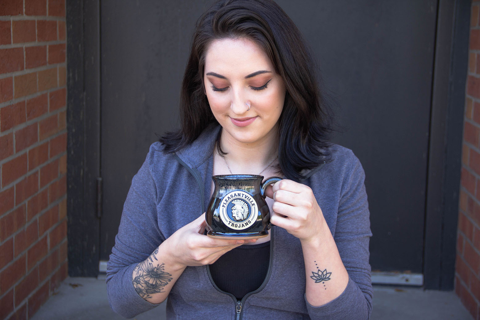 Woman posing with a stoneware mug