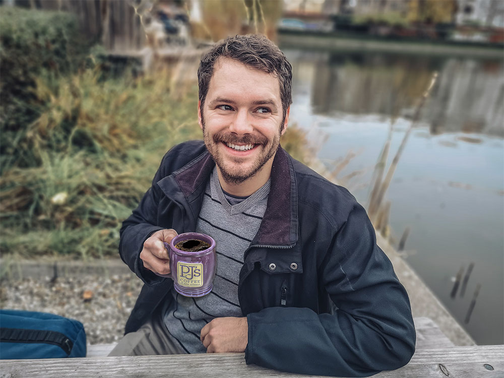 Man drinking coffee outside