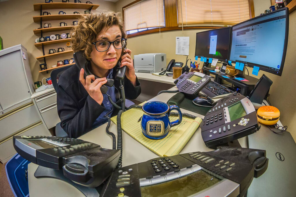 Person holding phones with a custom coffee mug